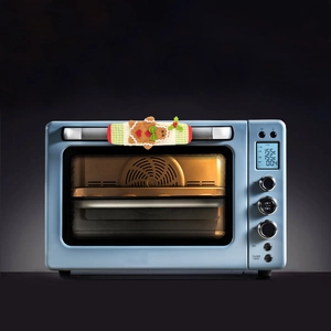 Blue retro electric oven with Christmas gingerbread handle cover and lighted interior