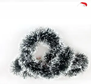 Detail of dark green Christmas tinsel with white tips for tree decoration