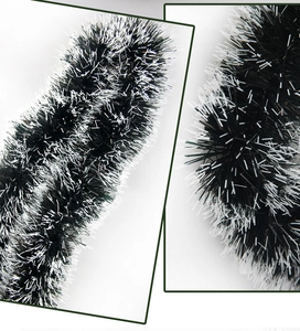 Detailed view of fluffy dark green and white tinsel garland for Christmas tree decoration