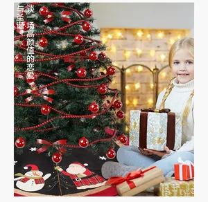 Detail of a 120cm black Christmas tree skirt with Santa Claus and snowman embroidery