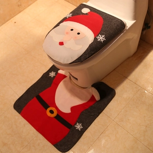 Detail of Christmas Santa toilet lid cover and U-shaped rug set with snowflake patterns