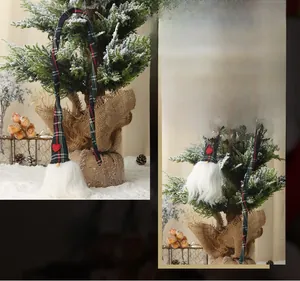 Détail d'un gnome de Noël avec long chapeau à carreaux suspendu au sapin de Noël