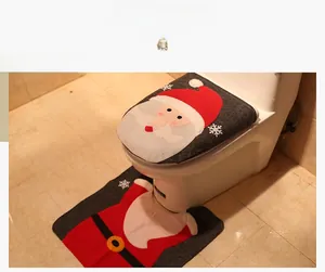 Detail of Christmas Santa Claus toilet seat cover and U-shaped rug set for bathroom decor