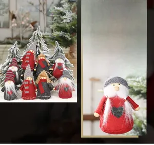 Detailed view of handmade Christmas gnome ornaments with felt hats and knit scarves