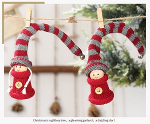 Close-up of knit Christmas elf ornaments with wooden heads and hanging clips