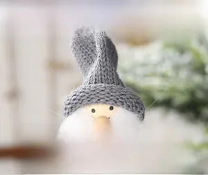 Detail of a Christmas gnome featuring a grey knitted hat and sand-filled weighted base