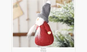 Side view of a festive Christmas gnome ornament with red felt body and grey knit hat
