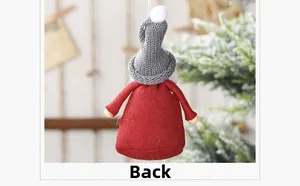Detailed back view of a red and grey Christmas gnome ornament hanging on a snowy tree