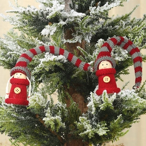 Handmade knitted Christmas gnome ornaments with long striped hats and wooden bells