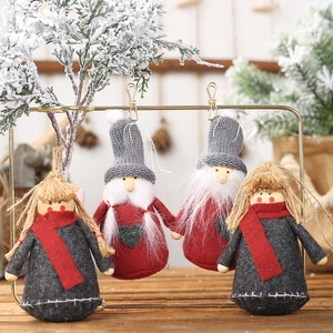Christmas plush doll ornaments set featuring red and grey gnomes on a wooden background