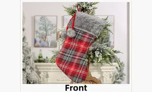 Front view of plaid Christmas stocking with grey faux fur trim hanging on decorative branch