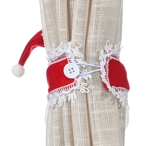 Red Christmas curtain tieback with white lace and Santa hat on a beige curtain