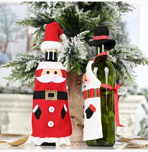 Close-up of Santa suit and snowman apron wine bottle covers for Christmas table decor