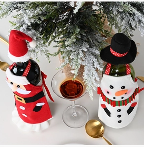 Detail of Christmas wine bottle apron and hat sets featuring Santa and snowman designs