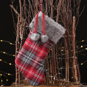 Classic snowflake plaid Christmas stocking with grey faux fur trim and pom-pom charms
