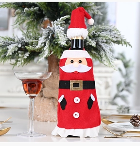 Detail of Christmas Santa wine bottle cover set with mini hat and belt on festive background
