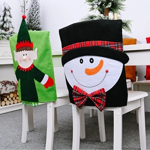Detail of elf and snowman non-woven chair back covers with red plaid bow Christmas decor