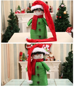Detail of green plaid snowman wine bottle cover with long red plush hat and pine cone buttons