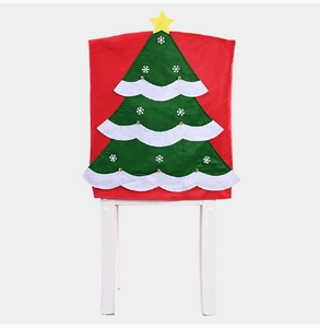 Detail of red Christmas chair cover featuring a green tree with a yellow star