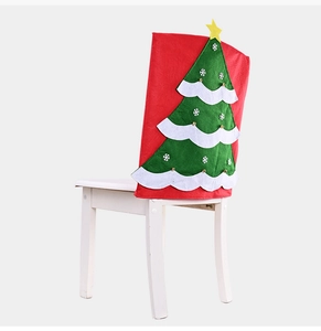 Detailed view of a red Christmas chair cover with a layered green tree and star design