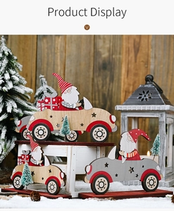 Three assorted wooden Santa Claus driving car ornaments with miniature pine trees