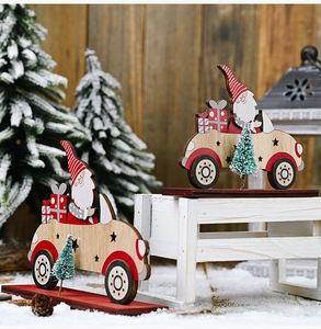 Detail of wooden Santa driving car ornament with mini pine tree and gift box decor