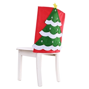 Festive Christmas chair back cover with green tree design on red non-woven fabric