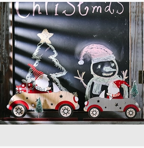 Detailed view of wooden Santa Claus car ornaments with star cutouts and plaid gift boxes