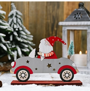 Macro detail of painted wooden Santa Claus car figurine on a festive snow background