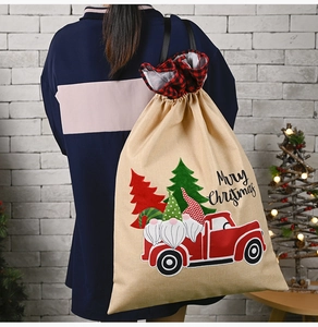 Detailed view of burlap Christmas gift bag with gnome and vintage truck print