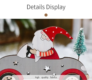 Detail display of wooden Santa Claus in grey car with green tree holiday ornament