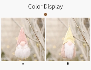Detail of plush Christmas gnomes with wooden base and hanging strings in pink and yellow