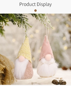 Detail showing two plush Christmas gnomes with knit hats and warm wooden bases