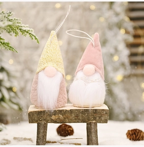 Detailed view of plush Christmas gnomes with knit hats and faux fur beards hanging set