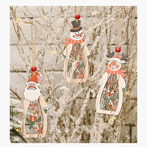 Close-up of wooden hollow Christmas ornaments with Santa, snowman and deer hanging on a tree