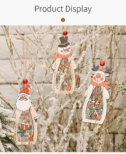 Detail of wooden hollow Christmas ornaments featuring Santa and snowman on snowy branches