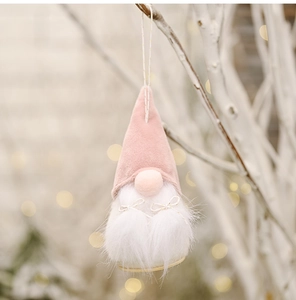 Pink and white Christmas gnome ornament with long white beard and a gold bow detail