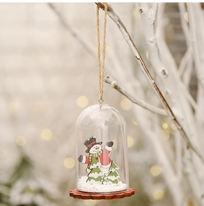 Detail view of a Christmas ornament dome featuring a wooden snowman and foam snow
