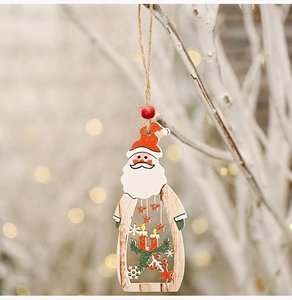 Detailed laser-cut wooden Santa ornament with festive hollow design hanging on a branch