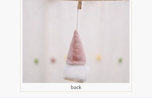 Back view of pink plush Christmas gnome pendant with round wooden base and white beard