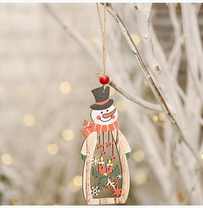Detail of wooden snowman ornament with hollow design and festive candle motifs