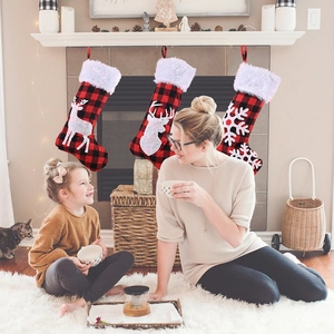 Red and black buffalo plaid Christmas stockings set with reindeer and snowflake patterns