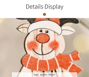 Close-up of wooden reindeer hanging ornament with festive red and white details
