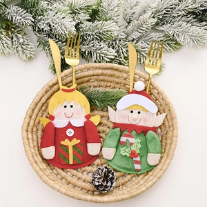 Christmas silverware holder set with angel and elf designs in a rustic basket