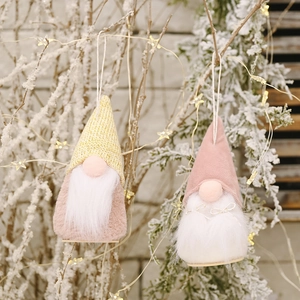 Hanging wooden base Christmas gnomes with knit hats and plush beards on snowy branches