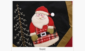 Detail of Christmas table runner with 3D plush Santa Claus and burlap fabric texture