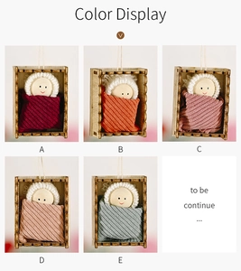 Detail of five miniature wooden doll ornaments in assorted colors for Christmas tree decor