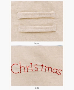 Détails d'un set de table en toile beige avec broderie de Noël rouge cousue main