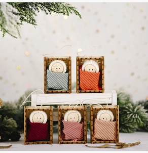 Detailed view of 5 wooden Christmas dolls with knit hats and hanging strings