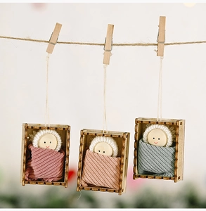 Three handmade Christmas dolls in wooden frames with knitted hats and striped fabric